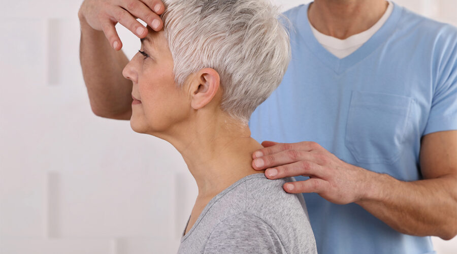 Senior women receiving neck and back physical therapy by male physical therapist