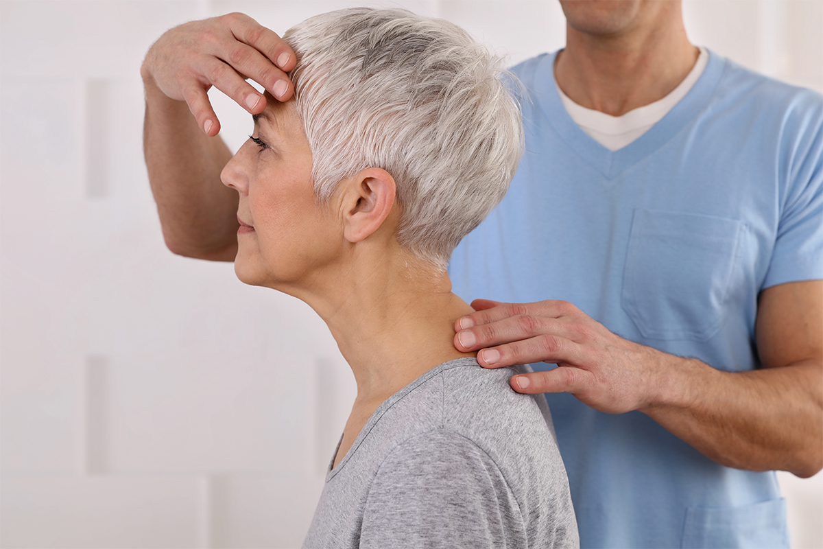 Senior women receiving neck and back physical therapy by male physical therapist