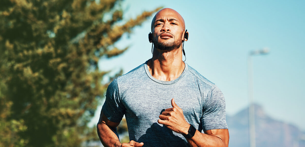 man running earphones during at hot summer day