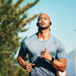 man running earphones during at hot summer day