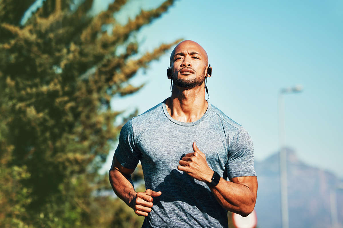 man running earphones during at hot summer day