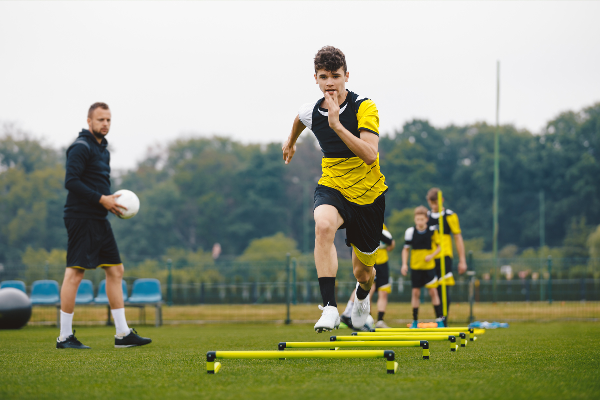 A group of teens practicing sport training drills in the field
