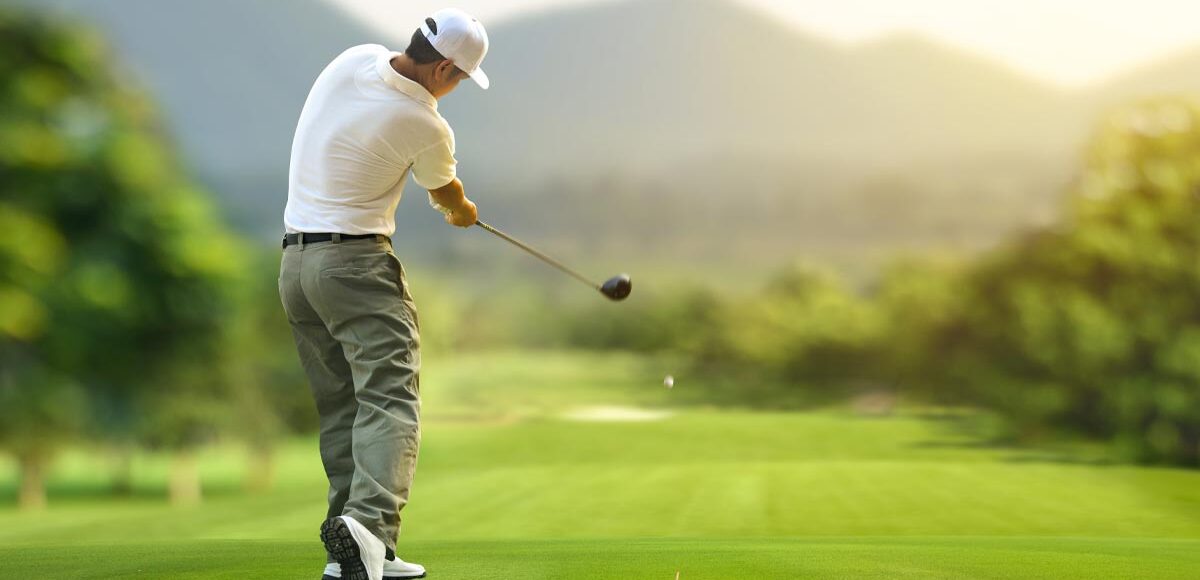 Man doing a proper golf swing in the golf course.