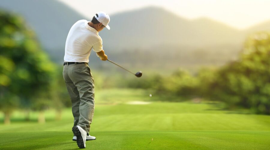 Man doing a proper golf swing in the golf course.
