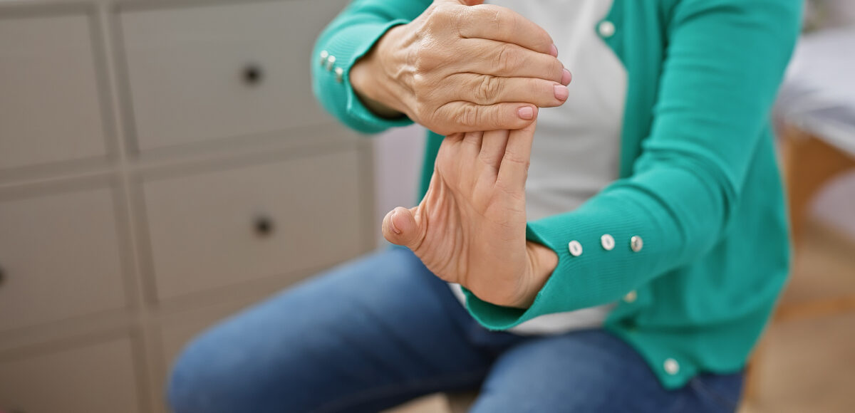 Woman doing a hand stretch fingers, hands and wrists exercise