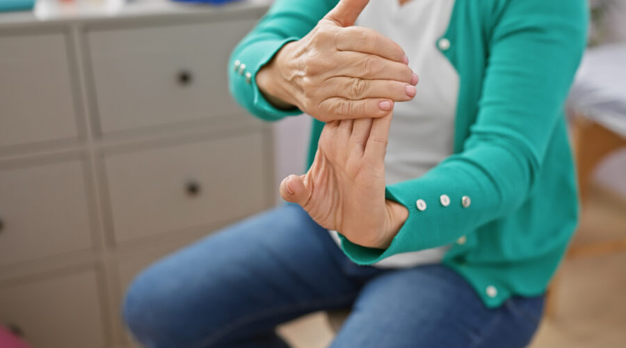 Woman doing a hand stretch fingers, hands and wrists exercise