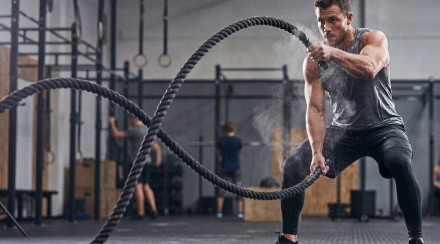 man doing battle rope exercises