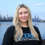 Vanessa Baggio of Scerbo Physical Therapy standing on the Hudson River Waterfront Walkway with the New York City skyline in the background.